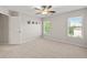 Spacious carpeted bedroom with a ceiling fan and two bright windows at 4440 Green Summers Dr, Cumming, GA 30028