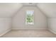 Bright carpeted bedroom with an attic window and neutral walls at 4440 Green Summers Dr, Cumming, GA 30028