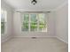 Cozy bedroom with carpet, neutral walls, and window with sheer curtains letting in natural light at 4440 Green Summers Dr, Cumming, GA 30028