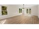 Bright dining room featuring hardwood floors, a chandelier, and multiple windows providing natural light at 4440 Green Summers Dr, Cumming, GA 30028