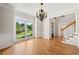 Bright dining room featuring hardwood floors and a large window overlooking the lawn at 4440 Green Summers Dr, Cumming, GA 30028