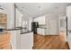 Bright kitchen boasts granite counters, stainless appliances, and hardwood floors at 4440 Green Summers Dr, Cumming, GA 30028