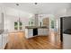 Open kitchen area with stone fireplace and plenty of natural light and hardwood floors at 4440 Green Summers Dr, Cumming, GA 30028