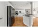 Bright kitchen features white cabinetry, stainless appliances, hardwood floors, and center island with seating at 4440 Green Summers Dr, Cumming, GA 30028