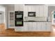 Kitchen boasts stainless ovens, tile backsplash, and granite countertop at 4440 Green Summers Dr, Cumming, GA 30028