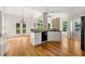 Bright kitchen area with stone fireplace and plenty of natural light and hardwood floors at 4440 Green Summers Dr, Cumming, GA 30028