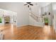 Spacious living room with hardwood floors, fireplace, and staircase at 4440 Green Summers Dr, Cumming, GA 30028