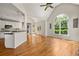 Bright open living area with kitchen island, hardwood floors, and soaring ceilings at 4440 Green Summers Dr, Cumming, GA 30028