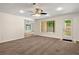 Spacious living room featuring modern ceiling fan, large window and access to the backyard at 4440 Green Summers Dr, Cumming, GA 30028