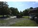 Long driveway with a carport provides plenty of parking spaces amidst mature trees at 1621 Oak Rd, Snellville, GA 30078