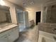 The bathroom features white cabinets, granite countertops, a shower, and a bathtub at 338 Cherryhill Ln, Woodstock, GA 30188