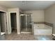 Modern bathroom featuring a separate shower, soaking tub, and neutral-toned tiles for a clean aesthetic at 338 Cherryhill Ln, Woodstock, GA 30188