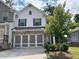 Two-story traditional home with a two-car garage and landscaped front yard at 338 Cherryhill Ln, Woodstock, GA 30188
