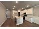 Bright kitchen with an island, white cabinets and stainless steel appliances at 338 Cherryhill Ln, Woodstock, GA 30188