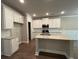 Modern kitchen features an island with a light countertop and stainless steel appliances at 338 Cherryhill Ln, Woodstock, GA 30188