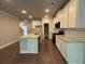 Bright kitchen features an island with a light countertop and stainless steel appliances at 338 Cherryhill Ln, Woodstock, GA 30188