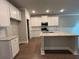 Bright kitchen features an island with a light countertop and stainless steel appliances at 338 Cherryhill Ln, Woodstock, GA 30188