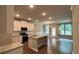 Bright open-concept kitchen with granite island, stainless appliances, and hardwood floors at 338 Cherryhill Ln, Woodstock, GA 30188