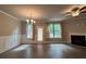 A bright, open-concept living room features lots of space, a fireplace, ceiling fan and hardwood floors at 338 Cherryhill Ln, Woodstock, GA 30188