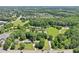 An aerial shot showcasing the property, its surrounding trees, and proximity to the neighborhood at 3388 Hamilton Mill Rd, Buford, GA 30519