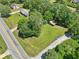 Aerial view of the property, highlighting the home, expansive yard, shed, and surrounding trees and street at 3388 Hamilton Mill Rd, Buford, GA 30519