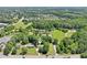 An aerial shot showcasing the property, its surrounding trees, and proximity to the neighborhood at 3388 Hamilton Mill Rd, Buford, GA 30519