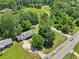 Aerial shot of the property, showing the home, shed, surrounding trees, green spaces, and neighborhood layout at 3388 Hamilton Mill Rd, Buford, GA 30519