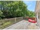 Wood back deck surrounded by green trees; a red item sits on the deck at 3388 Hamilton Mill Rd, Buford, GA 30519