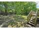 Large backyard with wood stairs leading up to the deck and a partially fenced-in area at 3388 Hamilton Mill Rd, Buford, GA 30519