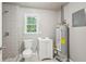 Small bathroom with patterned shower wall, modern fixtures, and an energy-efficient water heater at 3388 Hamilton Mill Rd, Buford, GA 30519