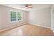 This bedroom features a large window that provides natural light and a ceiling fan at 3388 Hamilton Mill Rd, Buford, GA 30519