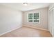 This bedroom features a large window that provides natural light and a closet with louvered doors at 3388 Hamilton Mill Rd, Buford, GA 30519