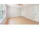 This bedroom has a large window, light-colored wood floors, and white trim at 3388 Hamilton Mill Rd, Buford, GA 30519