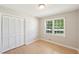 Bedroom featuring a closet and a bright window with neighborhood views at 3388 Hamilton Mill Rd, Buford, GA 30519