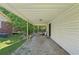 Covered carport area with gravel surface and access to the house and backyard at 3388 Hamilton Mill Rd, Buford, GA 30519