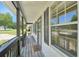 Inviting front porch with wood decking, white siding, dark shutters, and a 'home' welcome mat at 3388 Hamilton Mill Rd, Buford, GA 30519