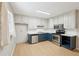Well-lit kitchen featuring white cabinets, stainless steel appliances, and light wood floors at 3388 Hamilton Mill Rd, Buford, GA 30519