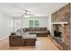 Spacious living room with natural light, a stone fireplace, and comfortable seating at 3388 Hamilton Mill Rd, Buford, GA 30519