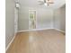 Living area with an exterior door, wood-look floors, and a view of a bathroom at 3388 Hamilton Mill Rd, Buford, GA 30519