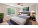 Well-decorated main bedroom featuring a comfortable bed, stylish decor, and a bright ceiling fan at 3388 Hamilton Mill Rd, Buford, GA 30519