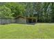 Detached shed with an attached carport offers convenient storage and parking solutions in the backyard at 3388 Hamilton Mill Rd, Buford, GA 30519