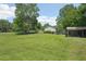 Scenic landscape showcasing the expansive yard with a shed, lush greenery, and serene neighborhood surroundings at 3388 Hamilton Mill Rd, Buford, GA 30519