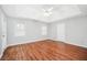 Spacious bedroom with vaulted ceilings, hardwood floors, a ceiling fan, and windows at 360 N Oakland Circle, Mcdonough, GA 30253