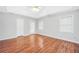 Spacious bedroom with vaulted ceilings, hardwood floors, a ceiling fan, and windows at 360 N Oakland Circle, Mcdonough, GA 30253