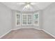 Bedroom with light-colored walls, carpet, a ceiling fan, and windows at 360 N Oakland Circle, Mcdonough, GA 30253