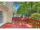 Backyard exterior view of wooden deck with bench seating and white siding on the house at 360 N Oakland Circle, Mcdonough, GA 30253