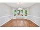 Bright dining area featuring hardwood floors and a bay window with backyard views at 360 N Oakland Circle, Mcdonough, GA 30253