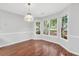 Bright dining area featuring hardwood floors and a bay window with backyard views at 360 N Oakland Circle, Mcdonough, GA 30253