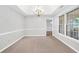 Formal dining room boasting wainscotting and an elegant chandelier at 360 N Oakland Circle, Mcdonough, GA 30253
