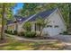 A charming ranch-style home showing the two car garage and well manicured landscaping at 360 N Oakland Circle, Mcdonough, GA 30253